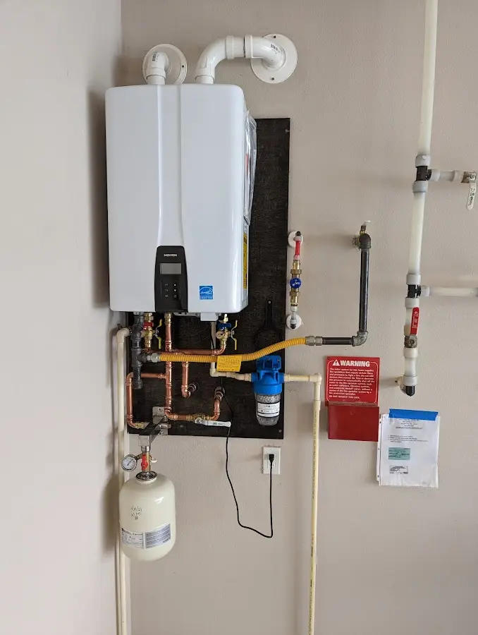 Professional plumber installing copper piping in a Sully Square home